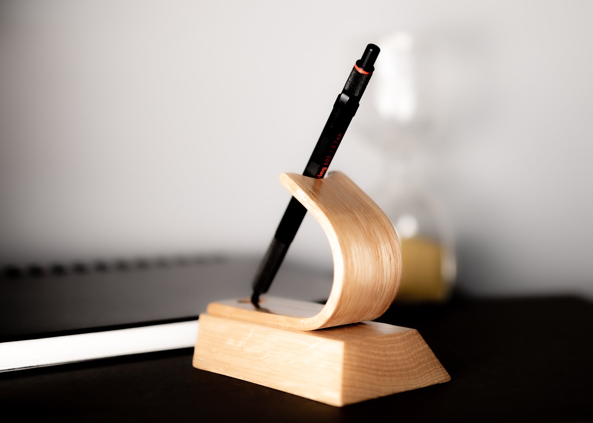 Pen on a wooden stand with a blurred background