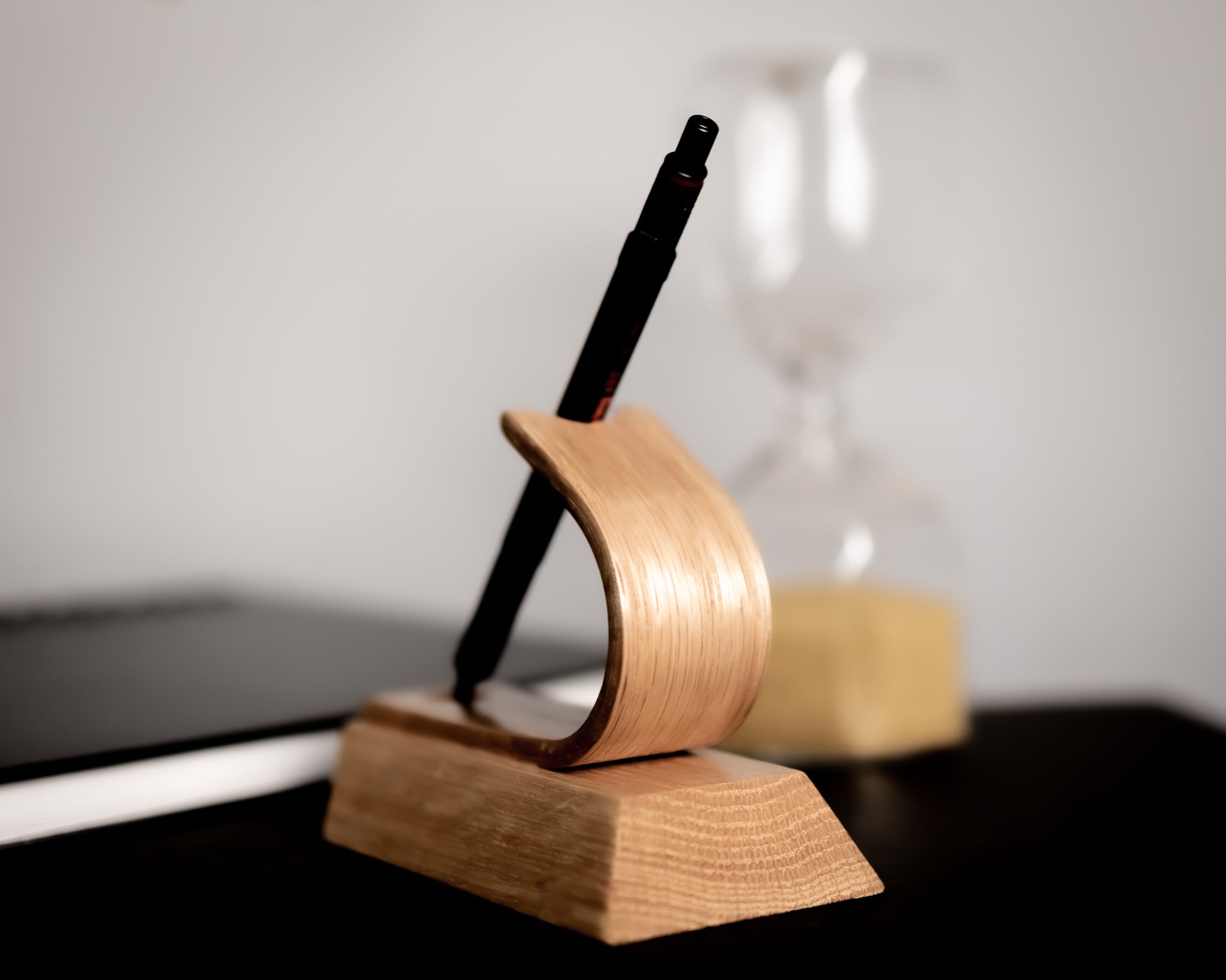 Wooden pen holder with a pen on a desk