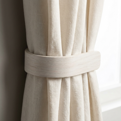 Close-up of a beige curtain with a wooden tieback against a neutral background