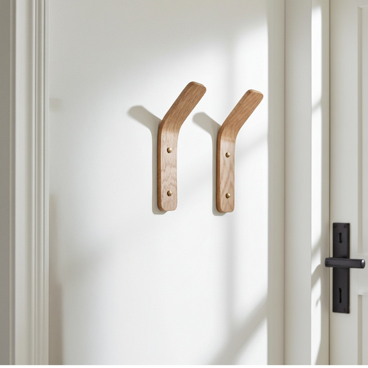 Two wooden wall coat hooks in a entryway in a home