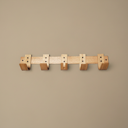 Wooden wall-mounted coat rack on a beige background
